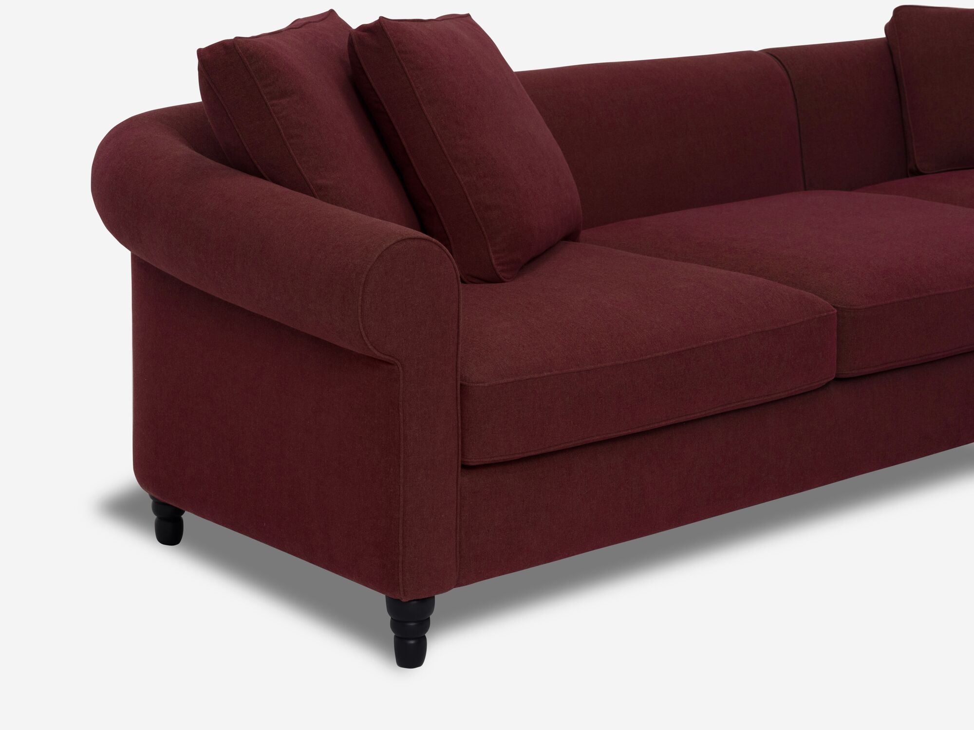 Front corner detail view of deep red modern sectional sofa